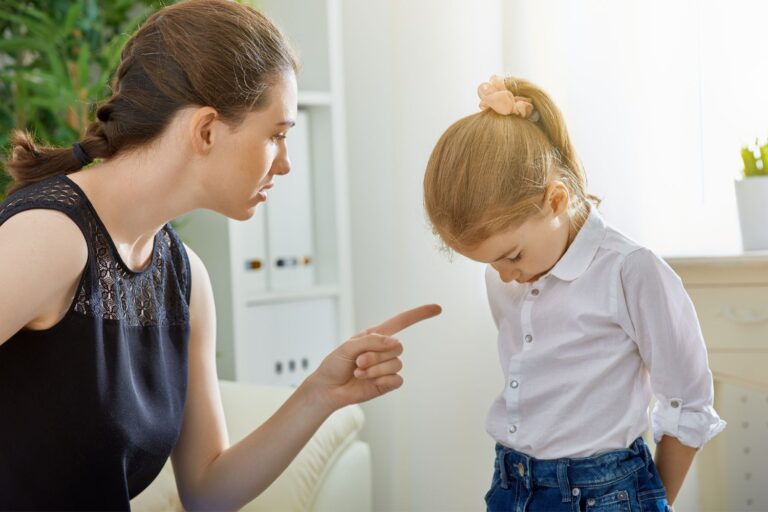 Mom pointing finger to child with head down showing difference discipline vs punishment